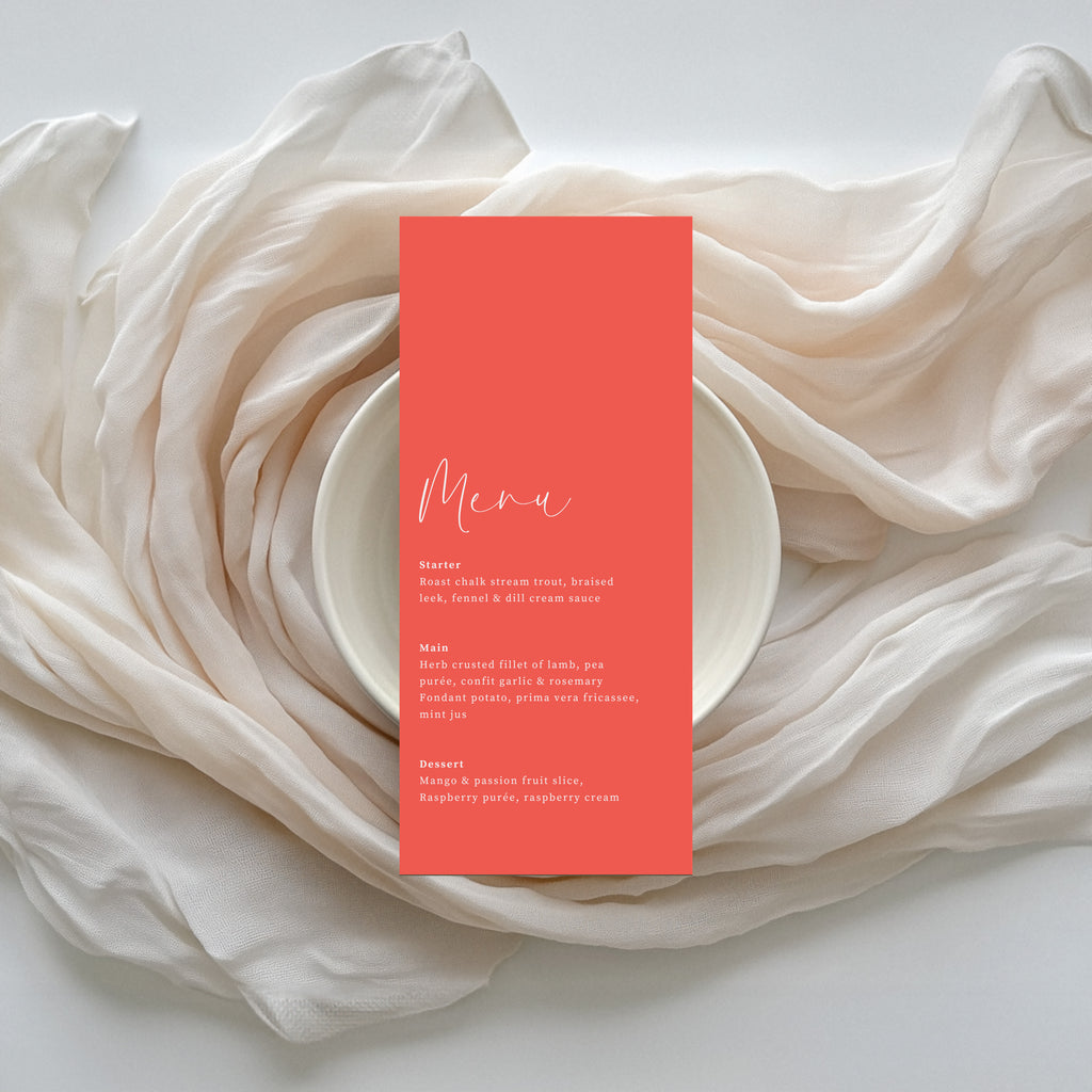 Willow personalised coral wedding menu on ivory silk linen backdrop.